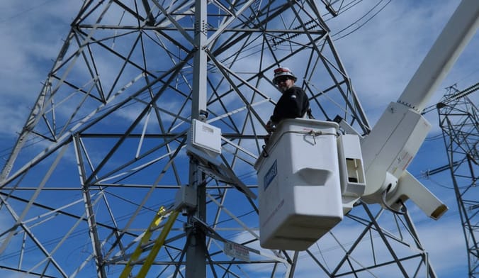 A LineVision sensor being installed on a National Grid transmission tower