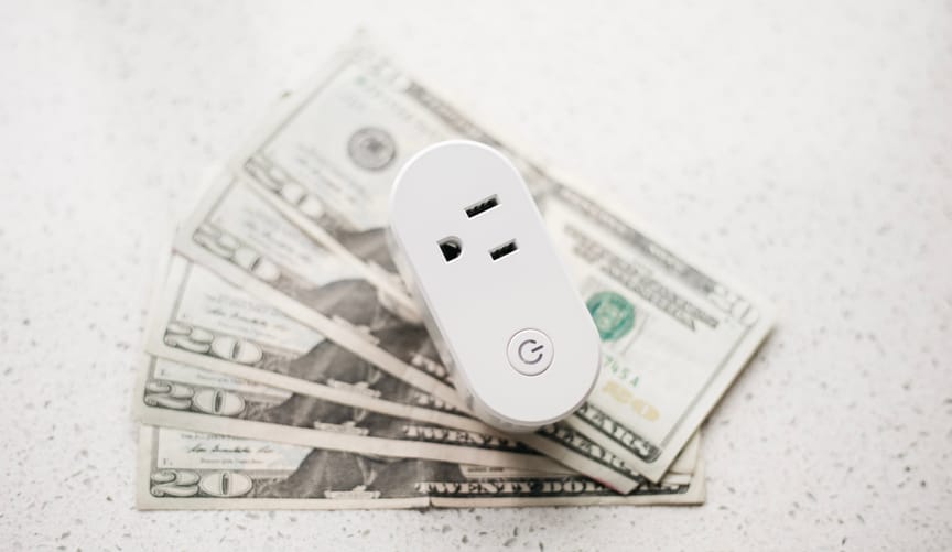 OhmConnect smart plug on top of pile of $20 bills