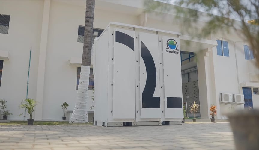 A large white metal box stands in front of an office building