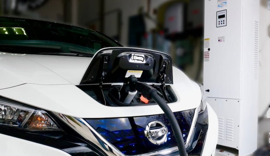 Nissan Leaf plugged into EV charger