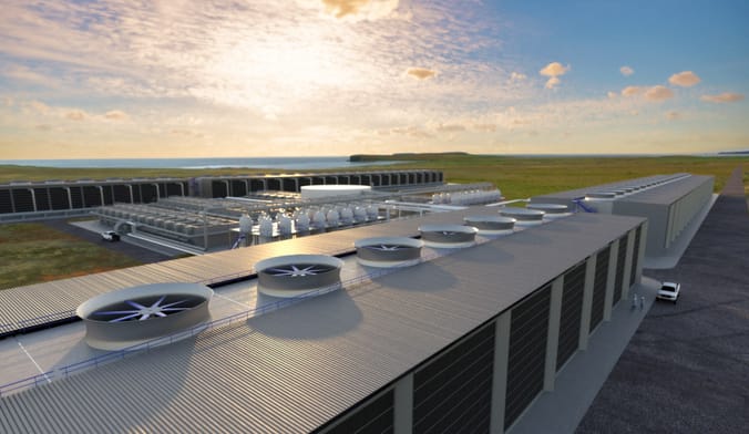 A large, sprawling white industrial facility with large circular intake fans on the roof