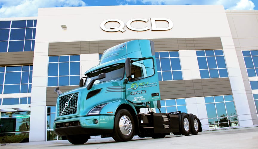Volvo VNR Electric truck parked in front of Quality Customized Distribution office in Southern California