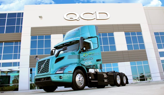 Volvo VNR Electric truck parked in front of Quality Customized Distribution office in Southern California