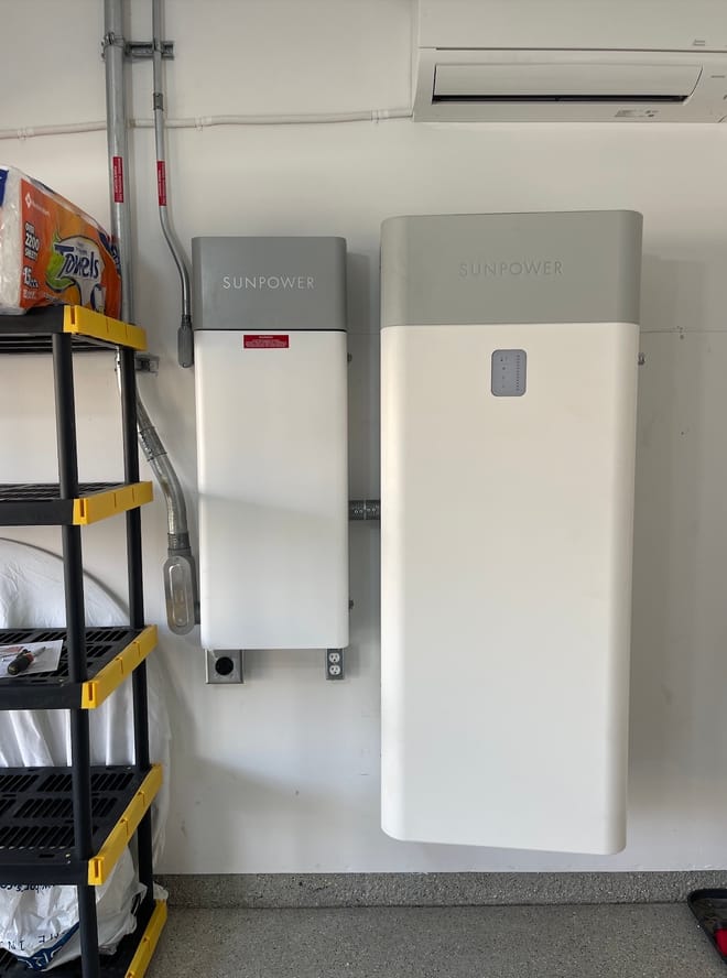two large rectangular white boxes mounted on the interior wall of a home's garage
