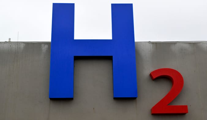A sign on a building reads H 2