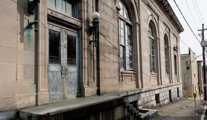 A stone building with weathered wooden doors