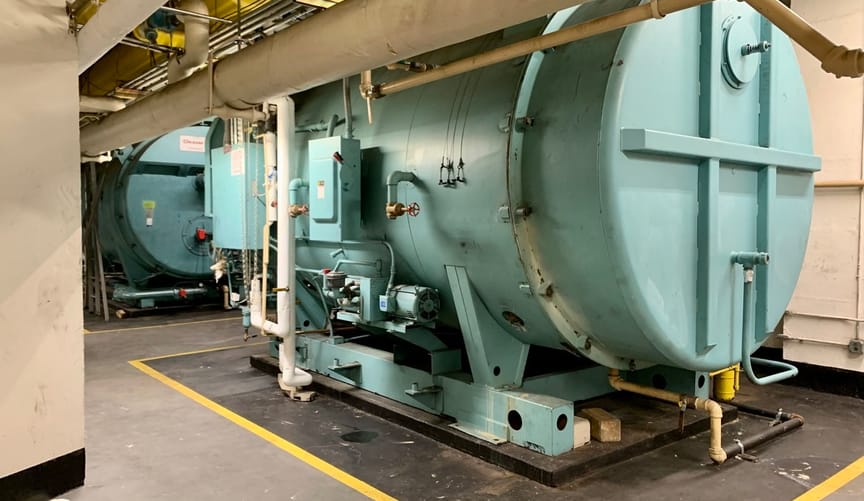 Two large light aqua tanks in a basement