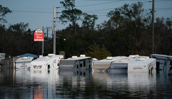 the tops of campers show above floodwaters at an RV park in Florida