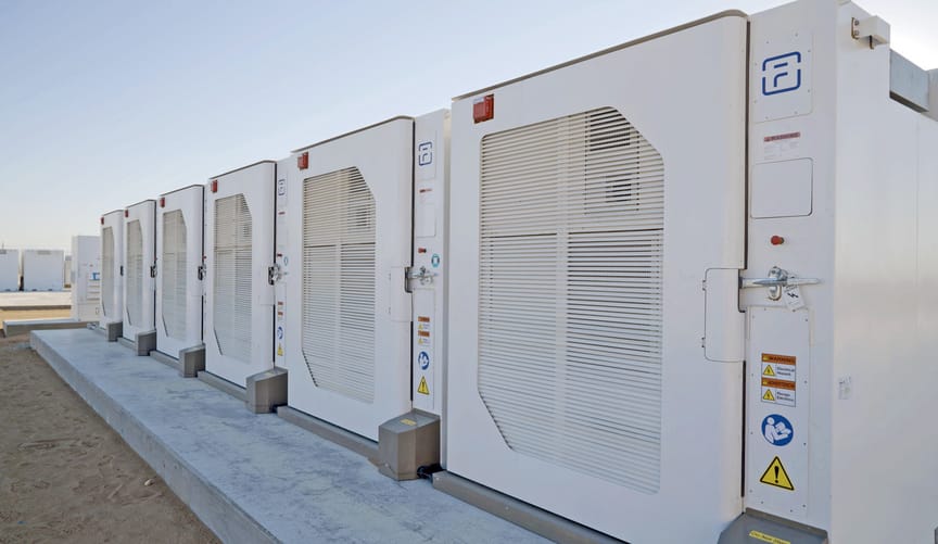 A row of white utility-scale battery units
