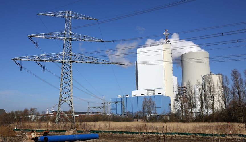 high-voltage transmission lines in front of the cooling tower at a coal-fired power plant