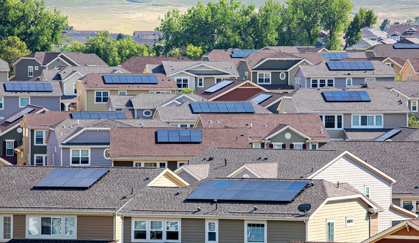 A dense residential neighborhood in Colorado with solar panels on almost every roof