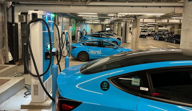 DC fast chargers charging Revel EVs in a garage in Queens