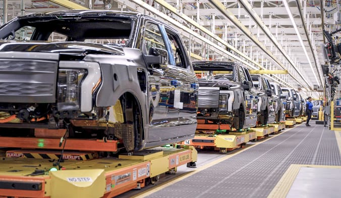 Ford F-150 EV trucks on the assembly line in a Michigan plant.