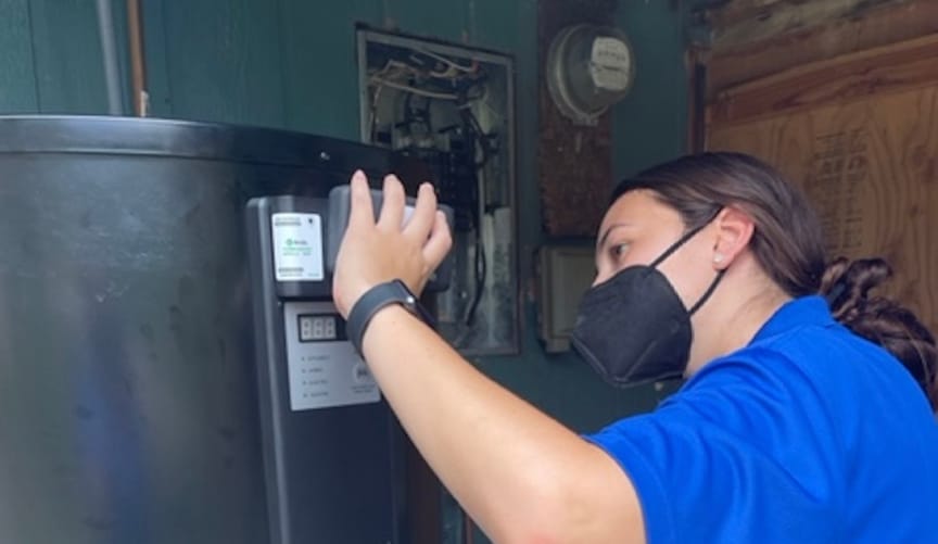 A contractor installs a Shifted Energy water heater control module in a Hawaiian home