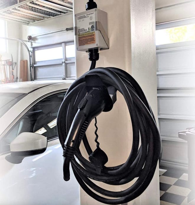 Smartenit smart EV charging cord hanging in garage