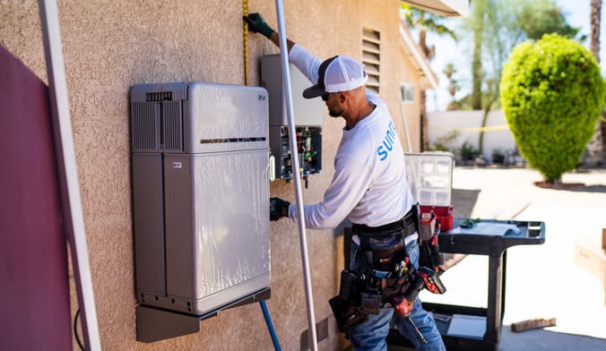 Sunrun employee installing an LG battery at a California home