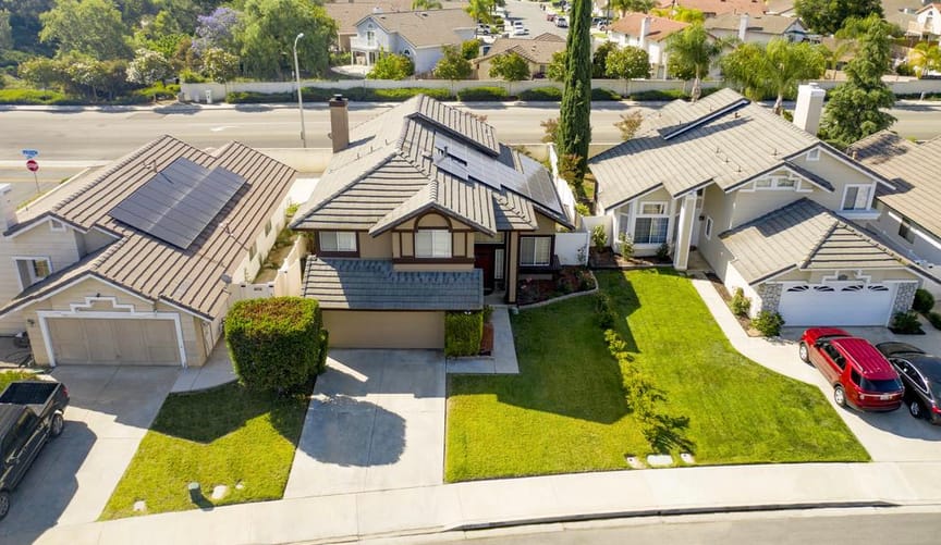 Suburban homes with solar panels on their roofs