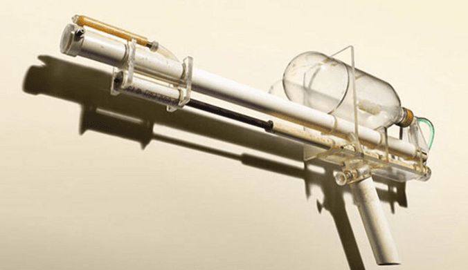 A gun-shaped object made out of white and clear plastic parts