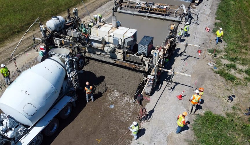 A truck pours concrete on to a test roadway in Minnesota.