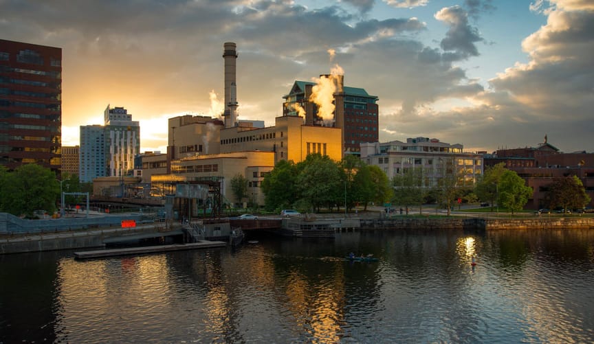 Vicinity Energy's Kendall steam plant in downtown Boston. An industrial complex surrounded by a pond.