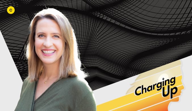 A smiling woman with a light skin tone and shoulder length blonde hair. A graphic overlay reads "CHARGING UP."