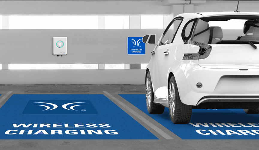 An illustration of a white car parked in an indoor lot with the words "wireless charging" painted on the ground